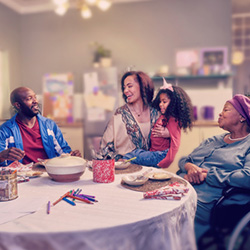 A family sitting at a table in their home